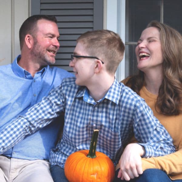 blog creator, her son, and husband sitting on front porch