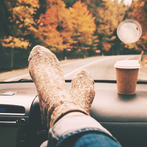 person with feet on dashboard of car