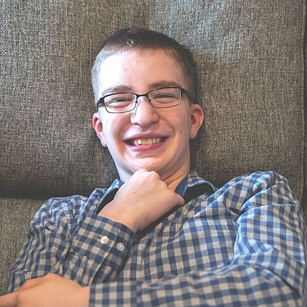 teen boy with developmental disabilities sitting on a couch