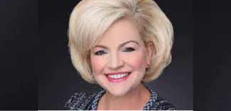 head shot of a causasian lady with blonde hair smiling