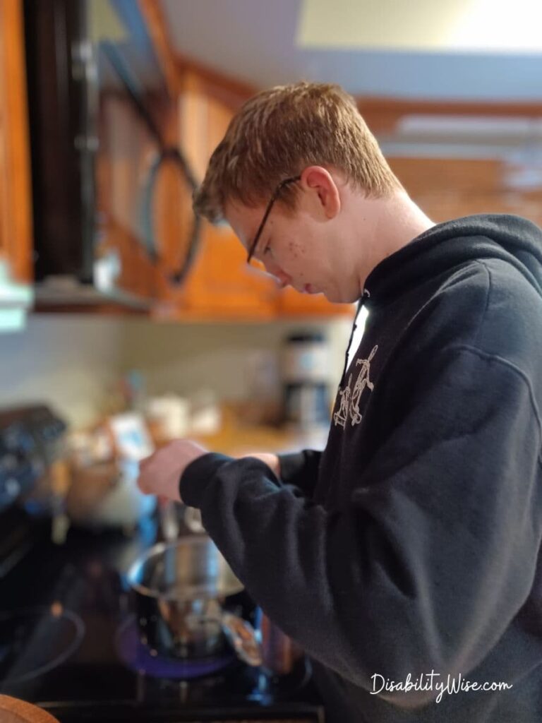 teen boy cooking at stove