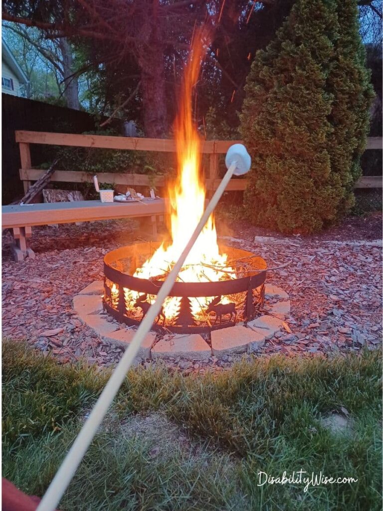 having smores at a firepit in backyard