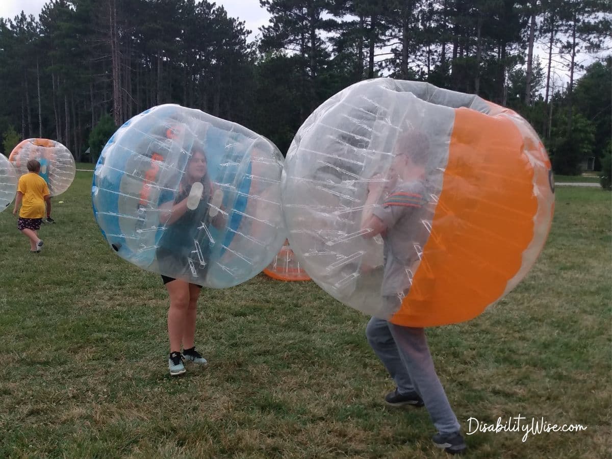 two teens in bubble suits enjoying summer