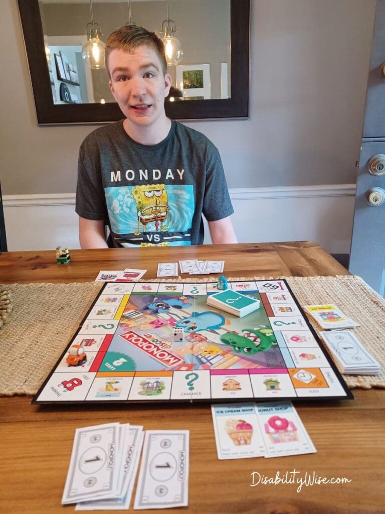 Teen boy learning skills in the summer by playing a board game 