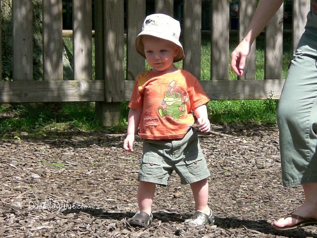 toddler walking on a playground 