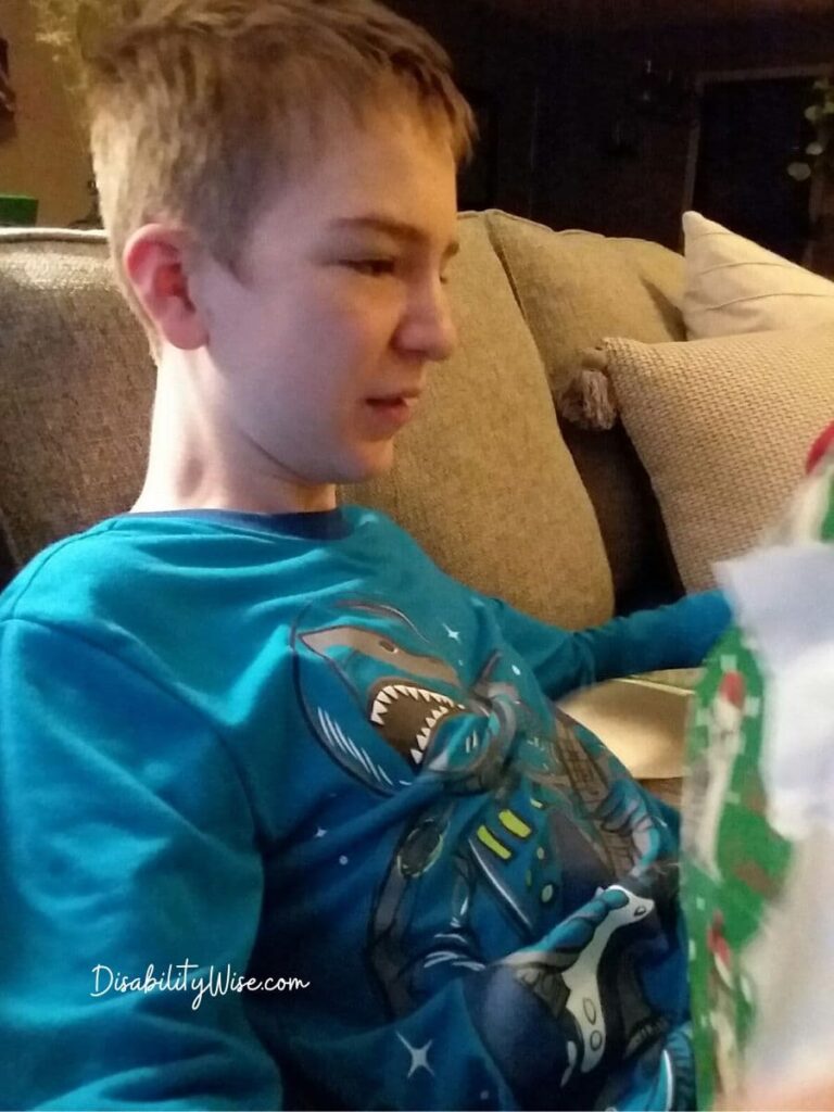 child opening holiday presents