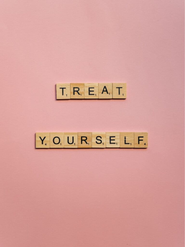 treat yourself sign on pink background