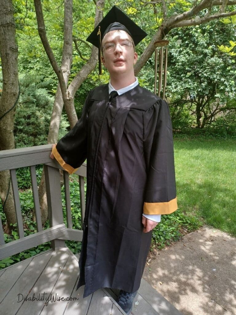 Grief of milestones, teenage boy with developmental disability in a cap and gown outside