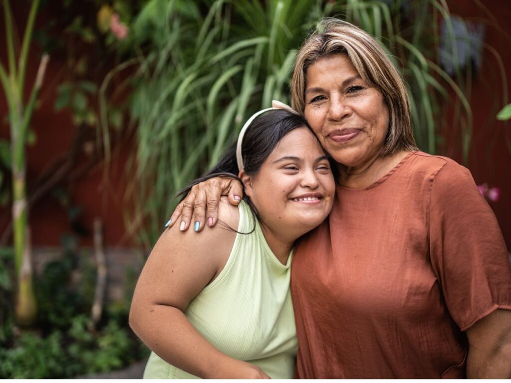 teen girl with developmental disabilities hugging her mom 